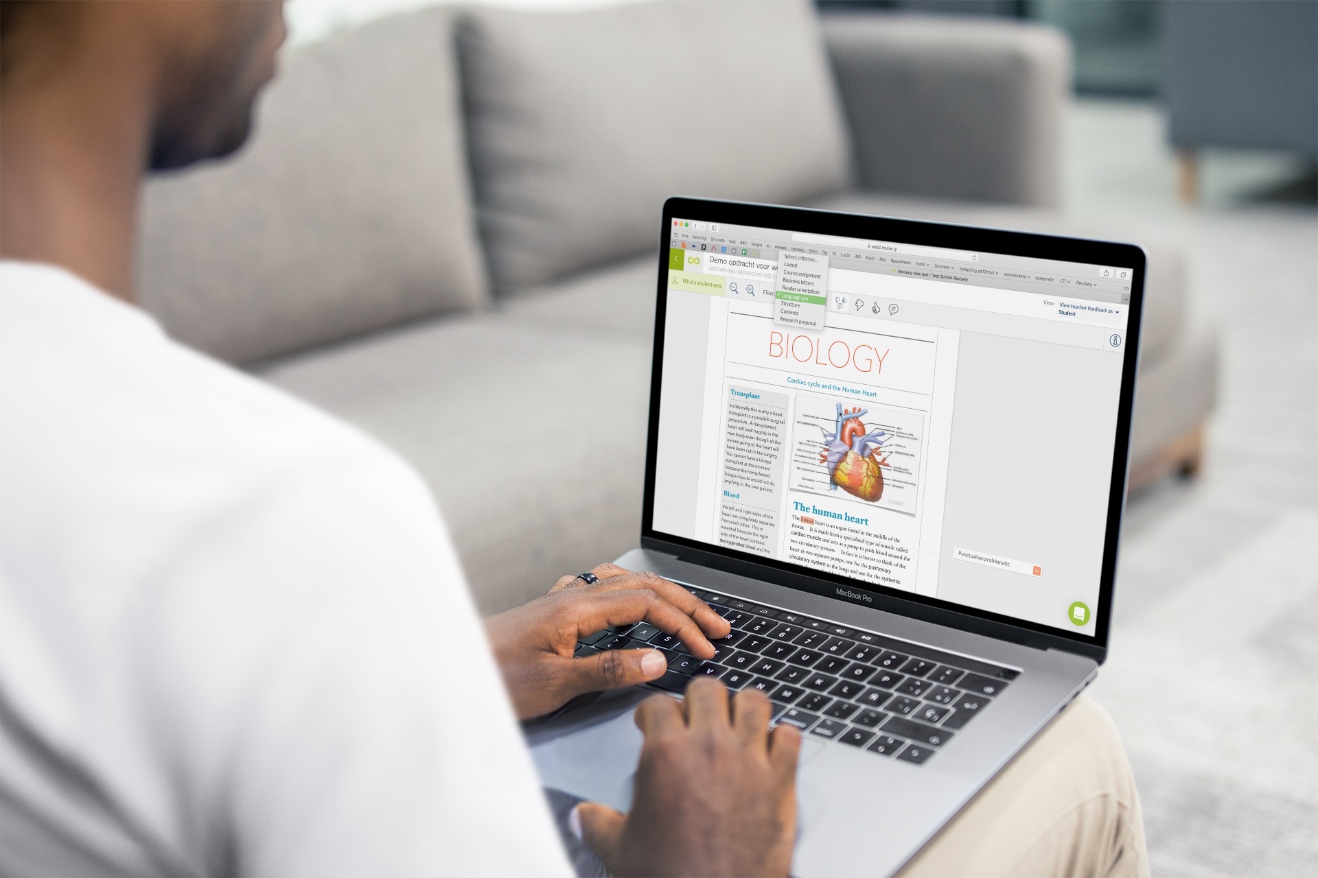 over-the-shoulder-shot-mockup-macbook-used-by-a-man-sitting-on-a-couch-a20536